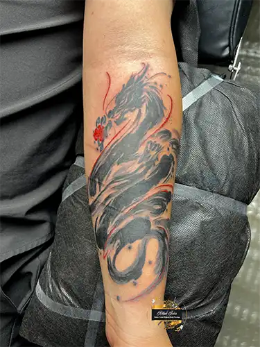 sumi-brushstroke-dragon-forearm-tattoo